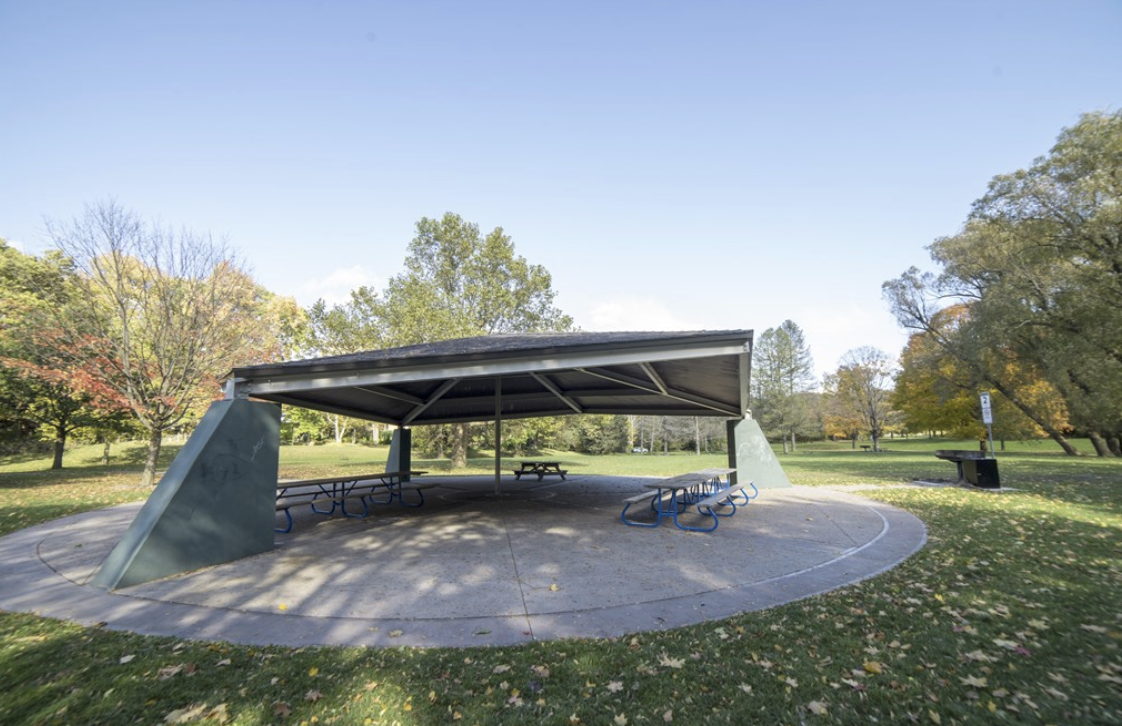 Open-sided picnic shelter with picnic tables at Gibbons Park Site 2, the event check-in location.